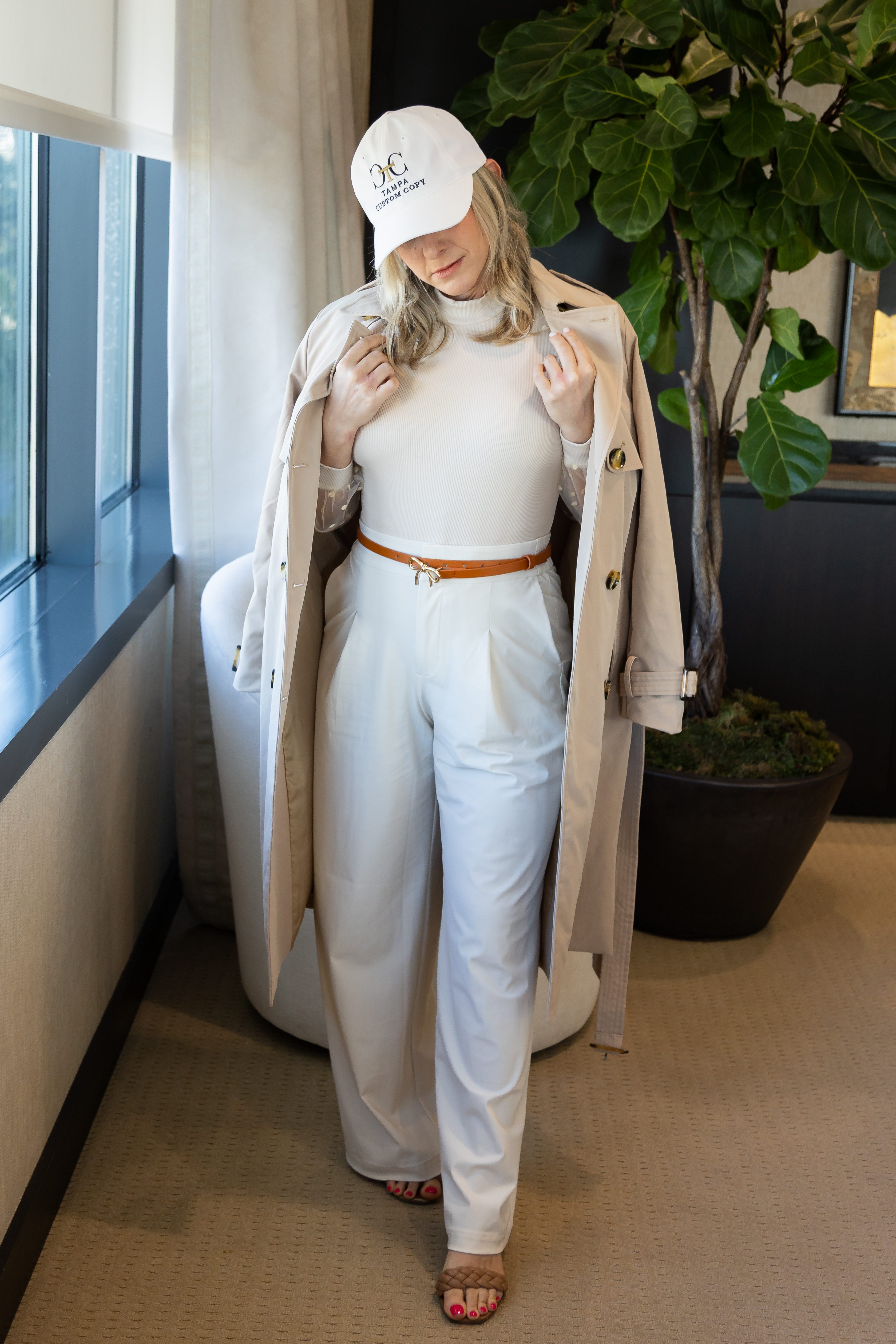 Ashley Wallach posing in professional business attire wearing Tampa Custom Copy hat